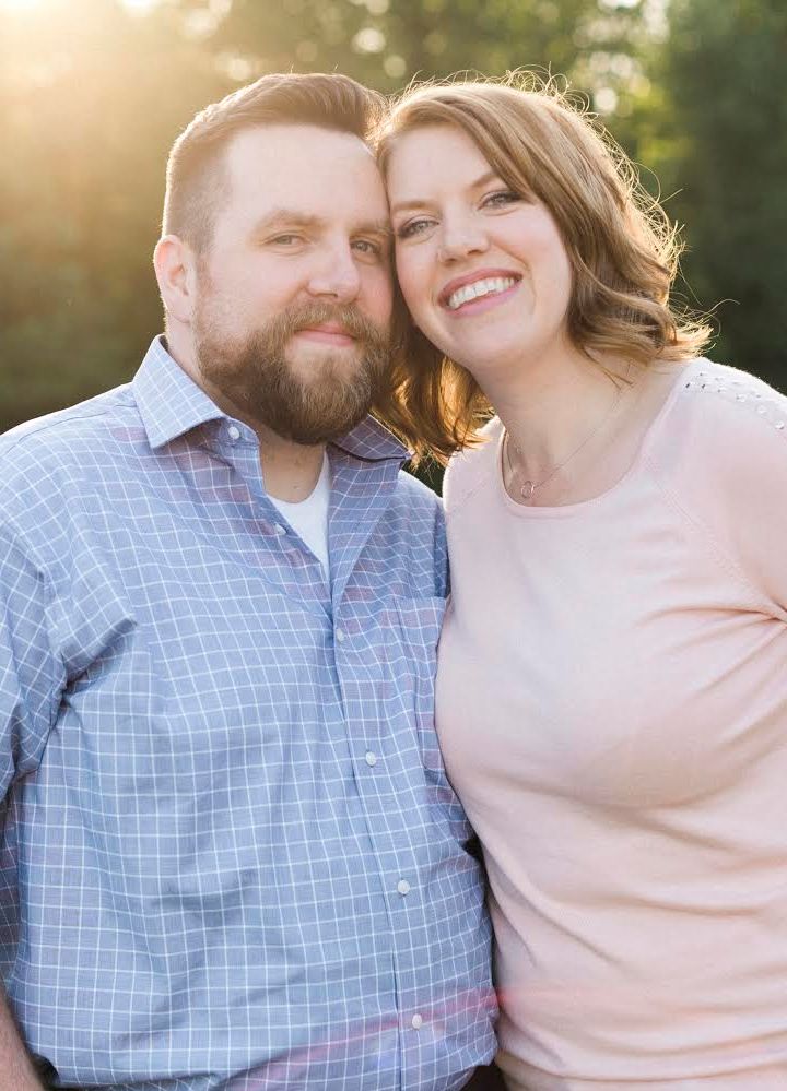 Jake Hawken and his wife smiling outdoors
